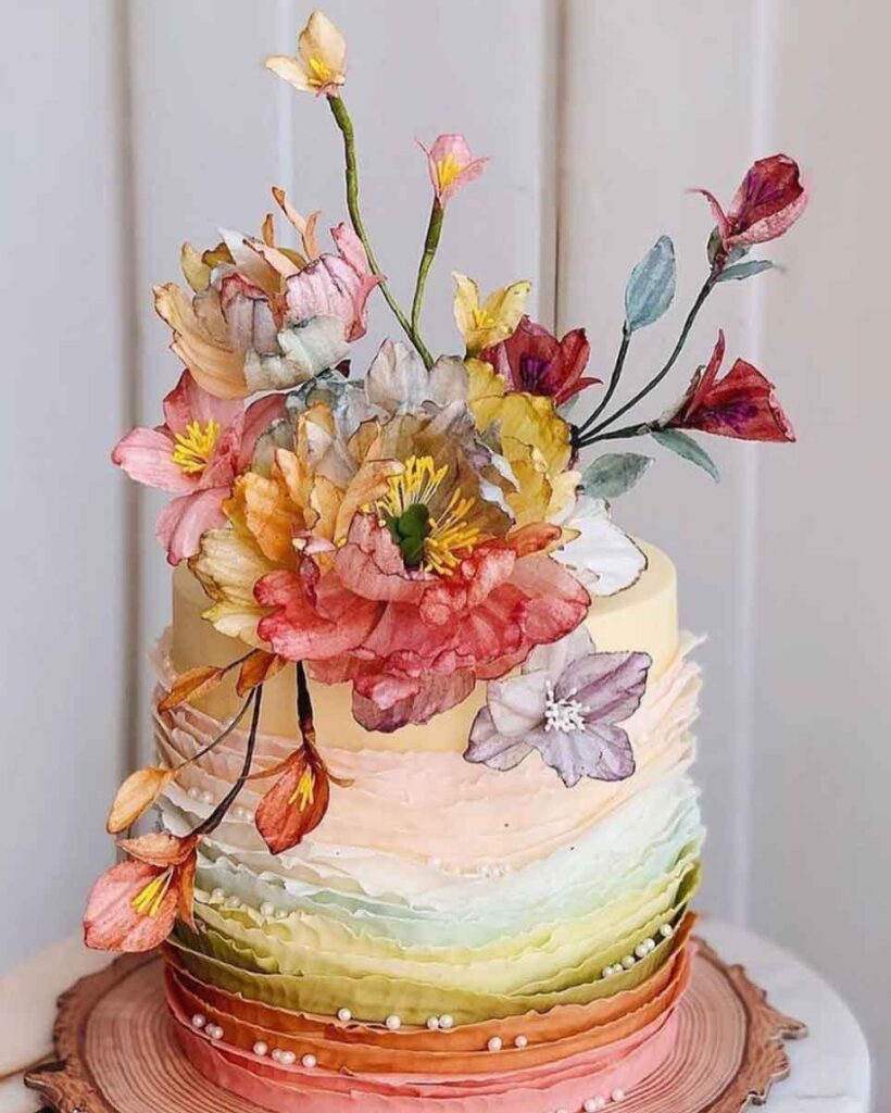 bolo feminino arco iris com flores redondo